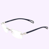 Maybach Optical Frame THE ARTIST IX P-AAS-Z25 by Maybach Sunglasses, featuring rectangular clear lenses, a silver metal bridge and hinges, and thin black arms, RX-ready and rimless, displayed on a light purple background.