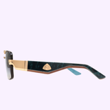 Showcased against a light purple backdrop, the Maybach SUNGLASSES THE PRESIDENT II PA-WEV-M10 by Maybach Sunglasses feature stunning gold and blue marbled arms, refined gold detailing near the hinge, and an elegant gold emblem on the side. Inspired by the renowned THE PRESIDENT II collection, these sunglasses epitomize sophistication.
