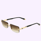 Gold and black rimless Maybach Optical Sunglasses, model THE SYMPHONY SUN I MG-ABM09, with brown gradient lenses, black arms, and gold accents, shown on a light purple background.