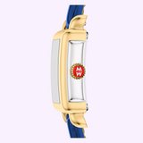 Side view of the Michele Watches Deco Madison Mini MWW06D000180 wristwatch in gold, featuring a navy leather strap and a red and gold crown engraved with the initials MW, set against a light purple background. This elegant timepiece from Michele Watches seamlessly blends sophistication with modern style.