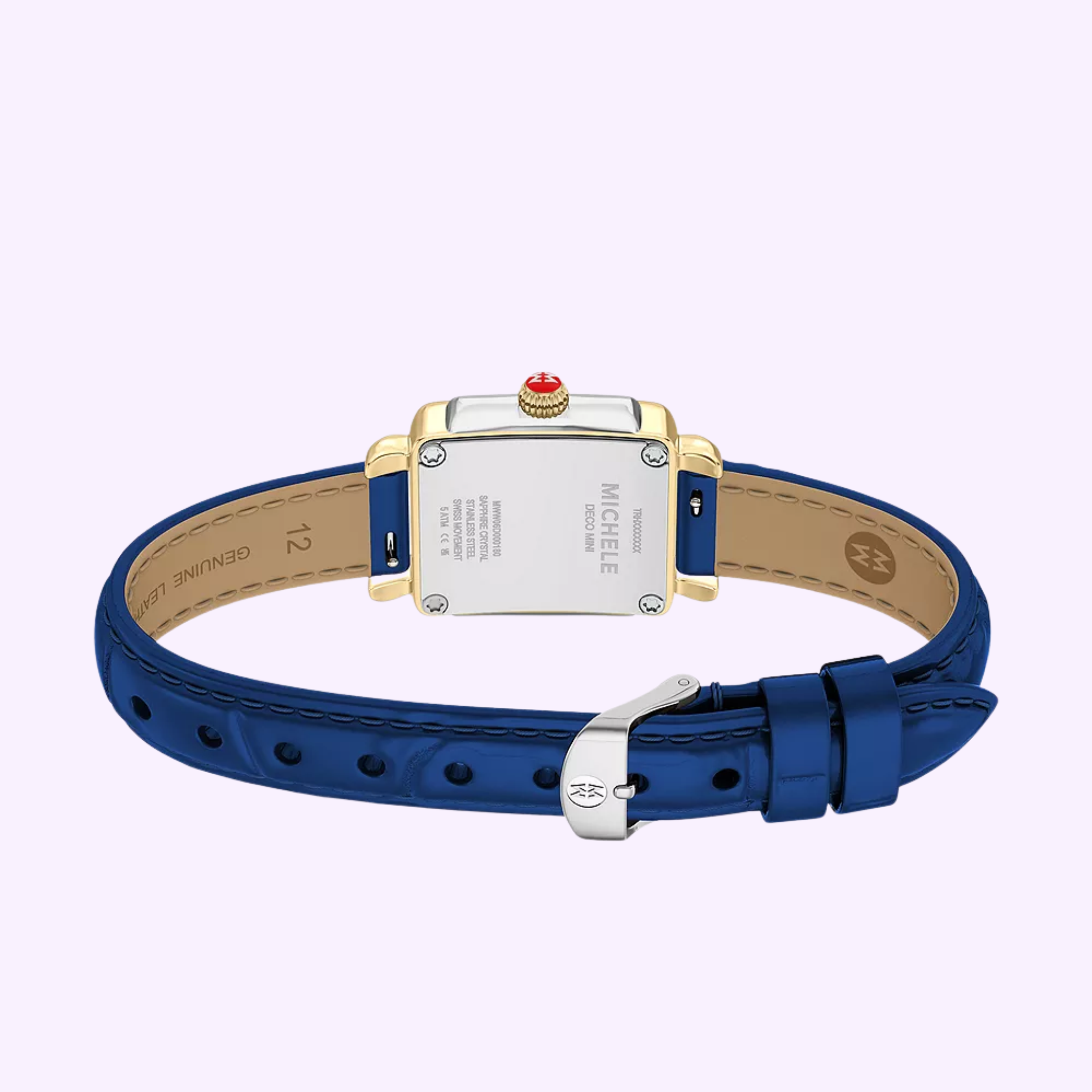 A blue leather Michele Watches Deco Madison Mini MWW06D000180 is shown from the back, highlighting its gold and silver case with Michele Watches branding and details, set against a light purple background. This elegant timepiece features a classic navy leather strap for timeless appeal.