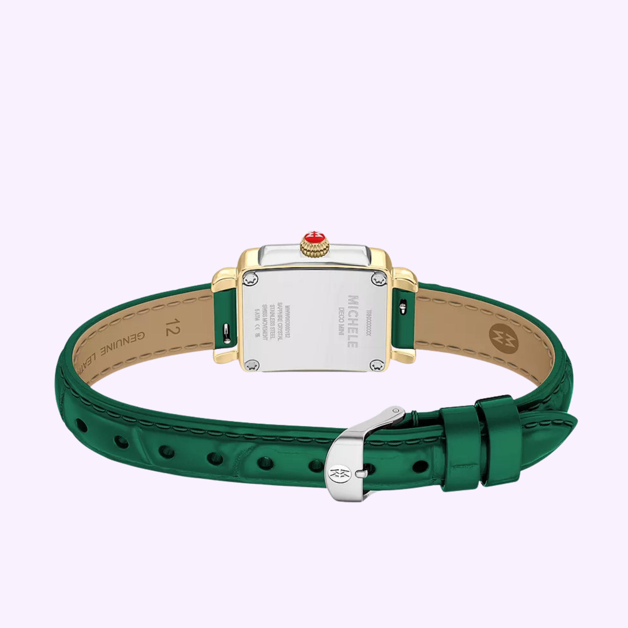 A Michele Watches Deco Madison Mini MWW06D000182 wristwatch by Michele Watches, featuring a green leather band, silver buckle, and a rectangular gold-trimmed case, is shown from the back to highlight its engraved details and signature red crown.