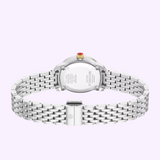 The Michele Watches Serein Oval Diamond MWW21H000005 is featured from the back, showcasing its metal link bracelet, signed clasp, and engraved case back with Michele Watches branding. The crown includes a red accent that enhances its elegant design. Powered by Swiss movement, this sophisticated timepiece is presented against a pale purple background.