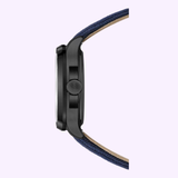 Side view of the Mido Watch Multifort TV Big Date M0495263704100 by Mido Watches, featuring a black case, visible crown, and blue fabric strap against a light background. Refined automatic movement; watch face not shown.