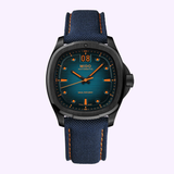 The Mido Watch Multifort TV Big Date M0495263704100 by Mido Watches features a blue textured strap, square black case, blue dial with orange details, and displays "MIDO" and "MULTIFORT," highlighting Swiss craftsmanship.