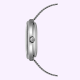 Side profile of a silver-toned Mido Watches Commander 1959 M842942511 wristwatch with a thin mesh strap and a prominent winding crown.