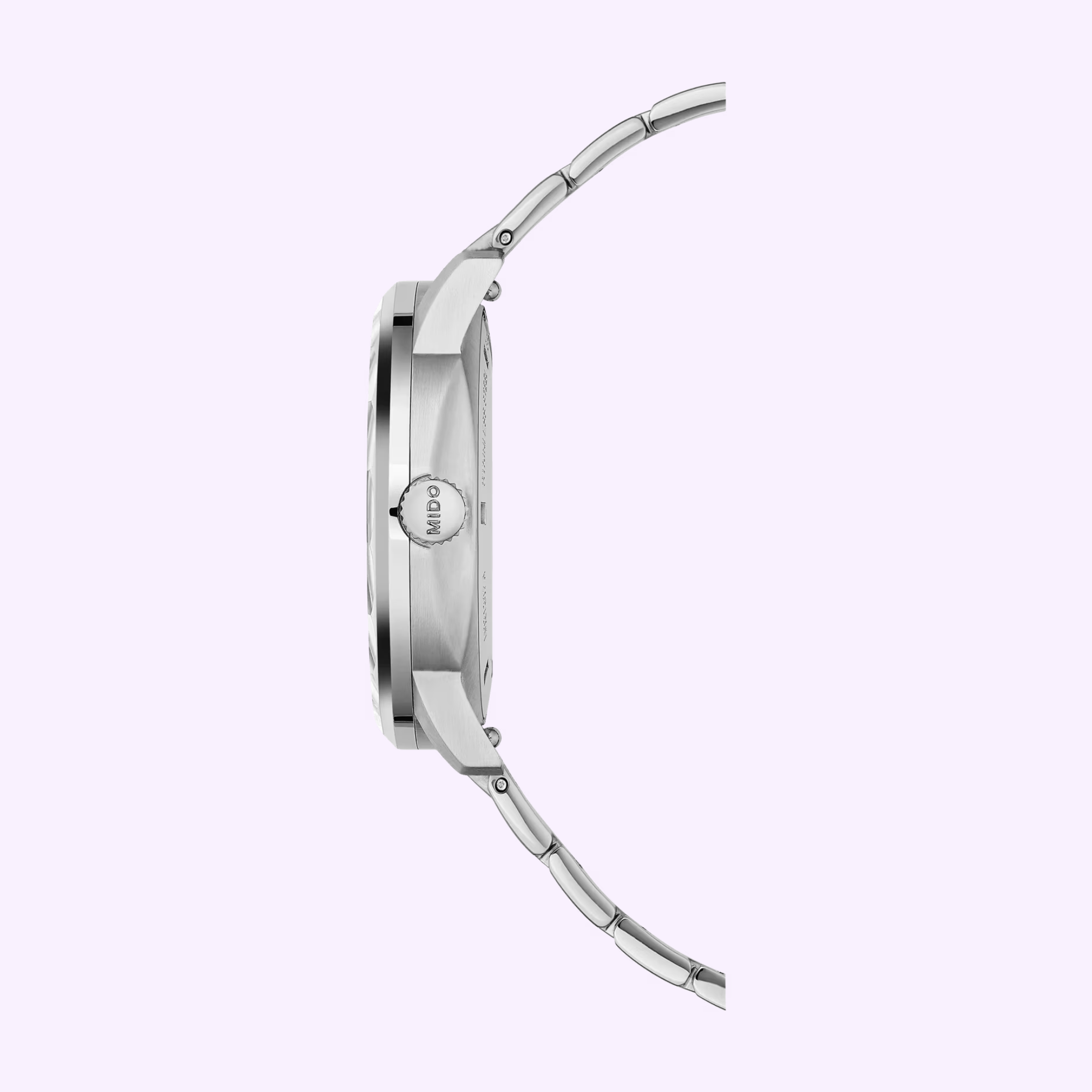 Side view of the Mido Watches Commander Lady M0212071104100, a silver automatic watch with metal band and round case, “Mido” engraved on the crown, set against a light purple background—an elegant timepiece.