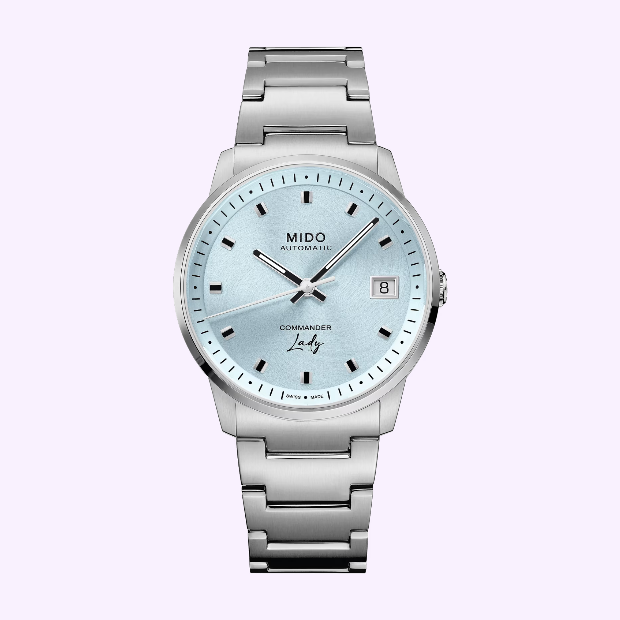 The Mido Watches Commander Lady M0212071104100 is a Swiss automatic watch with a metallic bracelet, light blue dial, silver hour markers, three hands, and a date window at 3 o’clock.