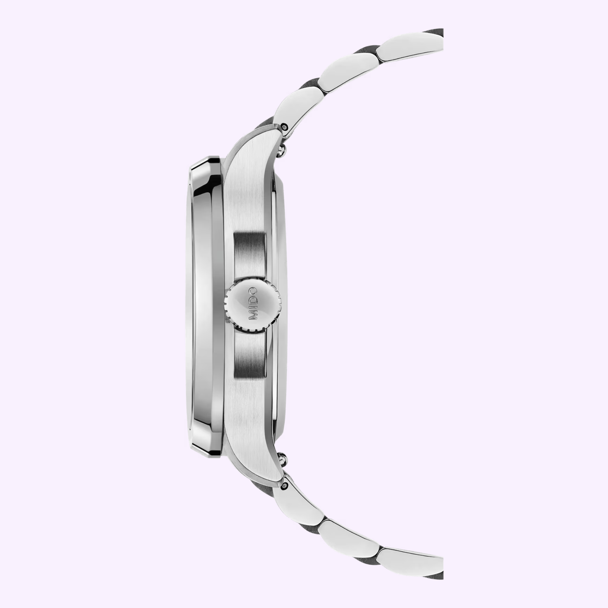 Side view of a silver metal Mido Watches Multifort TV Big Date Alebrijes M0495261108102 with round case, link bracelet, visible crown, and brushed finish. Background is light pastel purple.