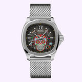 The Mido Watches Multifort TV Big Date Alebrijes M0495261108102 is a silver automatic watch with a mesh band and vibrant Day of the Dead sugar skull art on its black dial, powered by Caliber 80.