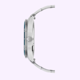 Side view of the Mido Watches Ocean Star 39 M0269071104101, showing a silver metal link band, round case, textured bezel, and right-side crown. The watch face edge looks dark against a light purple background.