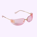 The Miu Miu Sunglasses 0MU A51S 5AK90Y75 feature pink-tinted lenses and gold rims and arms, offering a sophisticated and stylish look. A gold designer eyewear logo detail adorns the left lens for an unmistakable signature touch. These chic women’s Miu Miu Sunglasses are beautifully showcased against a light purple background.