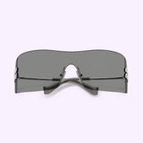 Futuristic, oversized Miu Miu sunglasses 0MU B53S 1BC81A44, featuring a single dark gray lens and thin black arms, displayed against a light background.