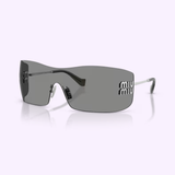 Sleek, rimless gray Miu Miu sunglasses 0MU B53S 1BC81A44 feature curved lenses and thin metal arms. The word MIU is printed twice in white on the right lens, showcasing their authentic Miu Miu Sunglasses design. The background is a pale, solid color.
