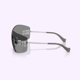 The Miu Miu sunglasses 0MU B53S 1BC81A44 by Miu Miu Sunglasses are displayed from the side, showcasing their gray lenses and sleek silver arms. The iconic white Miu Miu logo appears on the dark lenses, all set against a soft pale lavender background.
