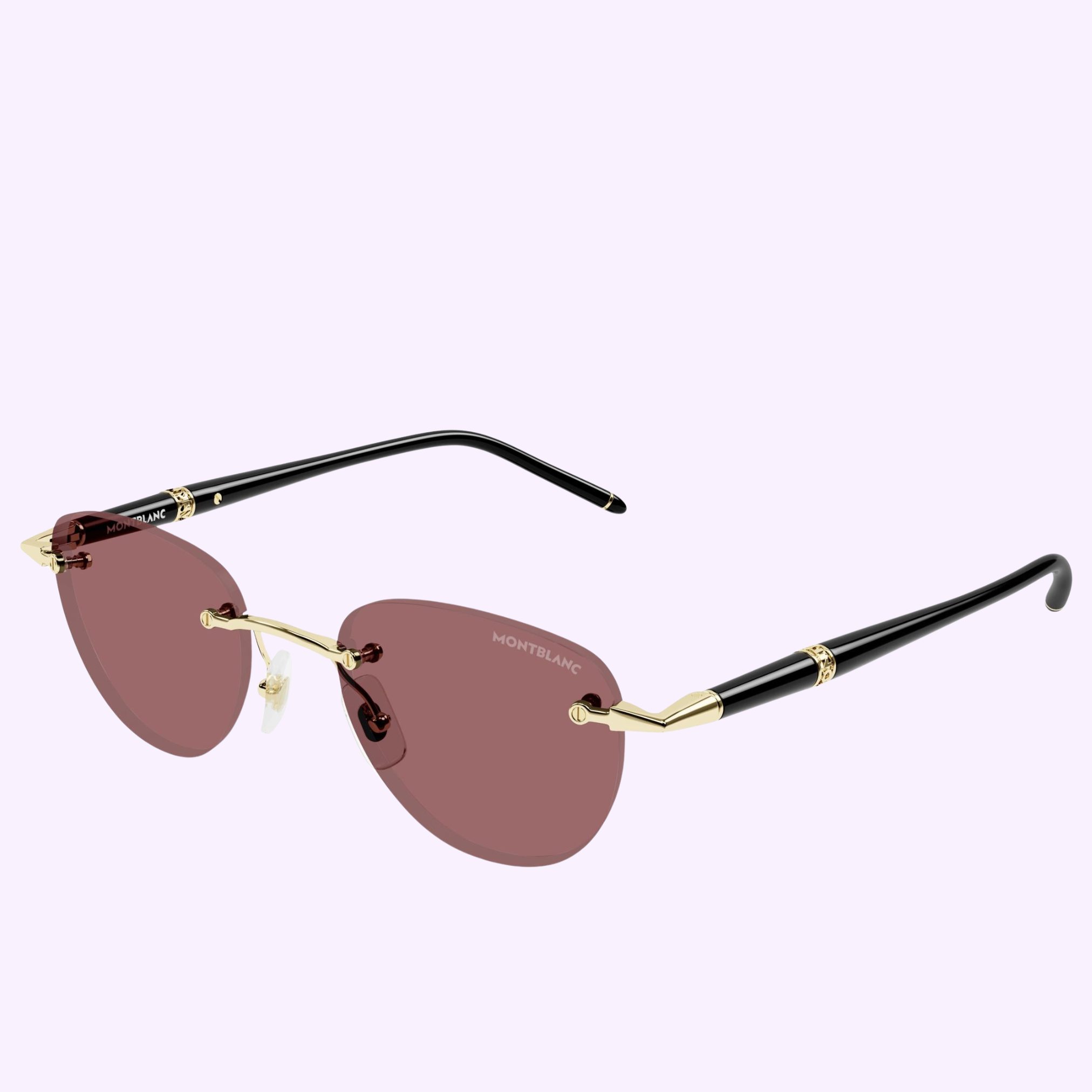 Montblanc Sunglasses MB0412S-003 48 feature rimless, heart-shaped lenses in a rose tint, complemented by a thin gold nose bridge and arms, and finished with black temple tips. The Montblanc logo is printed on the right lens, capturing the timeless elegance of Meisterstück-inspired eyewear. Displayed against a pale background, these Montblanc Sunglasses blend sophistication with playful design.