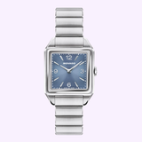 The Movado Watches 3650248 features a square blue dial, silver hour markers, and a stainless steel bracelet from Movado Watches, shown on a light purple background.