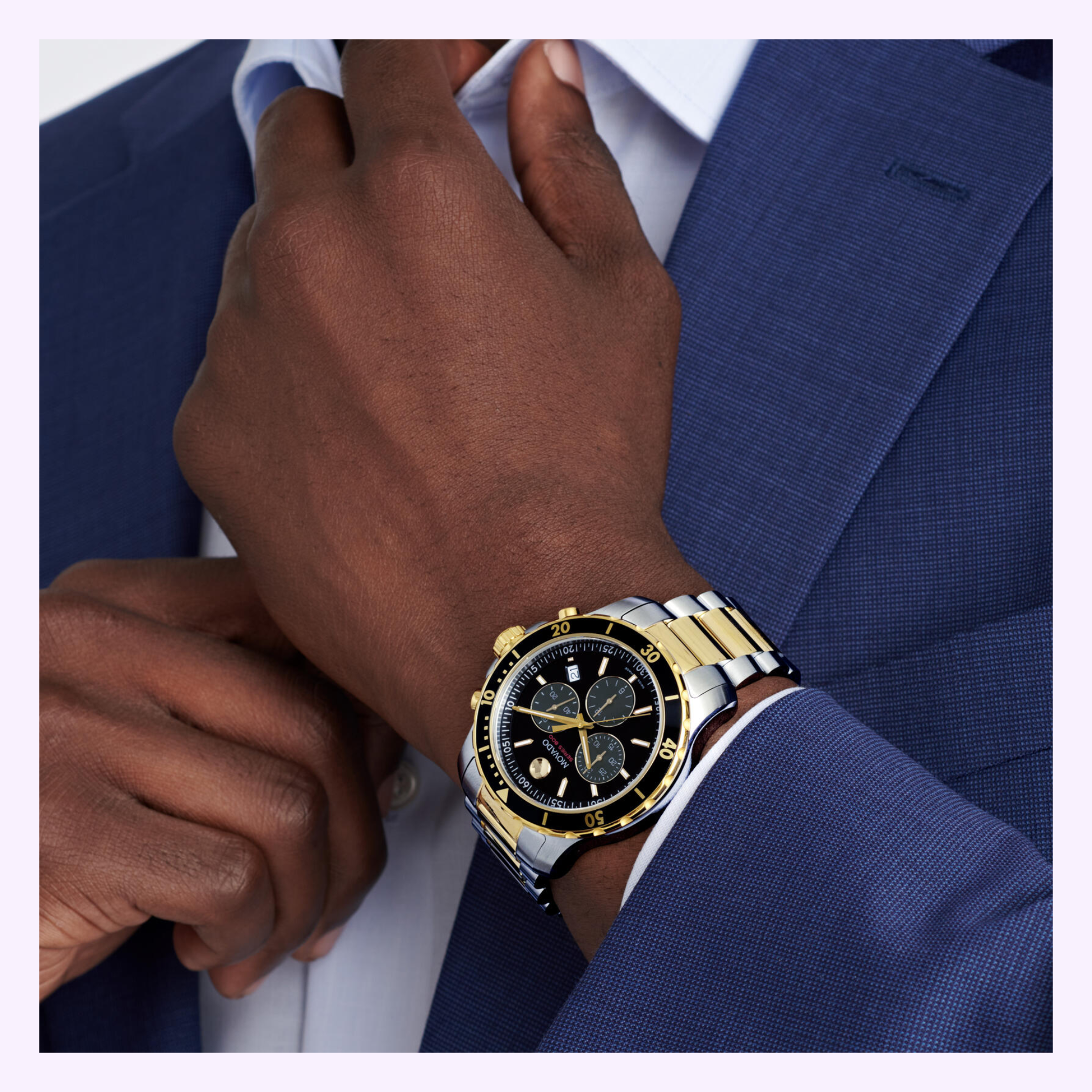 A person in a blue suit adjusts their collar, displaying a Movado Watches Series 800 Chronograph 2600146 with a stainless steel case and black dial on their left wrist.