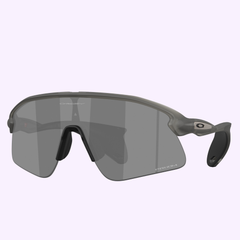 Oakley Sunglasses 0OO9517 95170139 feature a sleek, modern design with a large single gray lens, black nose pad, and gray frames. The right arm displays the Oakley O logo. Set against a light purple background. Inspired by Meta AI glasses innovation.