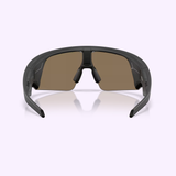 A pair of Oakley Meta Sunglasses 0OW8001 80010452, featuring a sporty wraparound design with dark rectangular lenses and a black frame, displayed from the front against a light purple background.