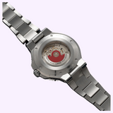 The stainless steel case back of an Oris Watches Aquis Date, featuring a transparent exhibition window that reveals the automatic movement and signature red rotor.