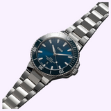 Oris Watches Aquis Date watch with a blue dial, metallic bezel, and stainless steel link bracelet.