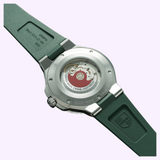 The exhibition case back of an Oris Watches Aquis Date wristwatch showing the mechanical movement and red rotor, attached to a green rubber strap.