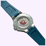 Back view of an Oris Watches Aquis Date featuring a blue rubber strap and an exhibition case back that reveals a red rotor movement.