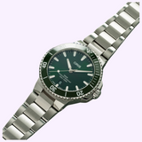 Oris Watches Aquis Date diver’s watch with a dark green dial, matching green bezel, and stainless steel link bracelet.