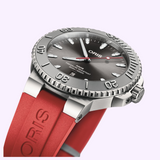 Oris Watches Aquis Date Relief analog dive watch featuring a grey sunburst dial, a grey relief bezel, and a red rubber strap.