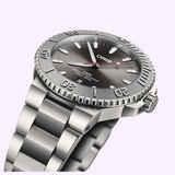 Oris Watches Aquis Date Relief stainless steel divers watch featuring a grey sunburst dial, a rotating bezel with raised numerals, and an automatic movement with a date window at six o’clock.
