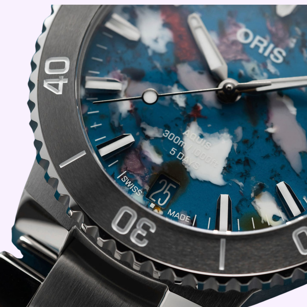 Close-up of the Oris Aquis Date Upcycle multicoloured recycled PET plastic dial with applied hour markers and date display