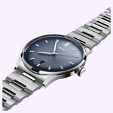 An Oris Watches Artelier Date silver wristwatch with a blue sunburst dial, metallic hour markers, and a date window at the six o’clock position, featuring a matching stainless steel link bracelet.