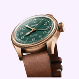 Bronze-tone Oris Watches Big Crown Pointer Date 80th Anniversary Edition with a green dial featuring a pointer date hand and a brown leather strap.