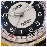 Close-up of an Oris Watches Big Crown Pointer Date Bullseye dial featuring a silver center, black hour ring with white Arabic numerals, and an outer date ring with red numerals indicated by a central red-tipped hand.