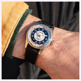 Oris Watches Big Crown Pointer Date Bullseye watch with a black and white bullseye dial, a red-tipped date hand, and a black leather strap worn on a wrist.