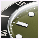Close-up of an Oris Watches Divers Date featuring a green dial, metallic indices, and a black rotating bezel with white numerals.