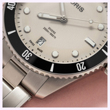 Close-up of an Oris Watches Divers Date with a silver dial, black rotating bezel, and a date window at the six o’clock position.