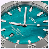 Close-up of an Oris Watches New York Harbor Limited Edition II with a teal dial, silver hands and indices, a date window at the six o’clock position, and a grey rotating bezel.