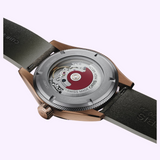 Exhibition case back of an Oris Watches ProPilot Bronze wristwatch, showing an exposed mechanical movement and a dark leather strap.