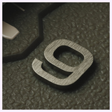 A metallic number nine digit on the textured green dial of an Oris Watches ProPilot Date.