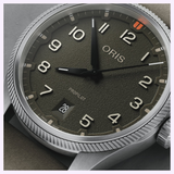 Oris Watches ProPilot Date featuring a textured olive green dial, white Arabic numerals, a date window at the 6 o’clock position, and a metallic, fluted bezel.
