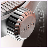 Close-up of an Oris Watches ProPilot Date metallic watch crown with the word ORIS embossed on the end.