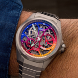 Oris Watches ProPilot X Gonzo Edition watch on a wrist with a rainbow-gradient skeletonized dial, white hands, and a circular power reserve indicator.