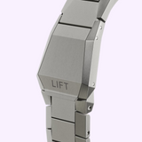 Close-up of a brushed metal Oris Watches ProPilot X Gonzo Edition watch bracelet clasp with the word LIFT engraved on the center link.