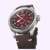 Oris Watches X Cervo Volante watch with a deep red dial, silver case, and brown Swiss deer leather strap.
