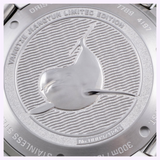 Close-up of the stainless steel case back of an Oris Watches Yangtze Jiangtun Limited Edition watch, featuring an embossed porpoise over a wavy pattern with the model name and limited edition number engraved around the border.