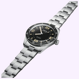 An Oris Watches Divers 60th Anniversary Edition stainless steel watch featuring a black dial, rotating bezel, and metal link bracelet.