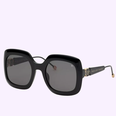 The PHILIPP PLEIN SPP065S Shiny Black 700 Women Sunglasses by Philipp Plein Sunglasses showcase an oversized square silhouette with dark lenses, highlighted by gold accents on the arms and signature branding on the side. These stylish women’s sunglasses are presented against a light background.
