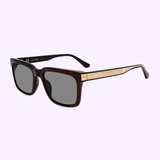 The Police SPLF12 0722 55 Women Sunglasses by Police Sunglasses feature rectangular dark lenses, a dark tortoiseshell and metal frame, and gold metal arms, shown against a light purple background.